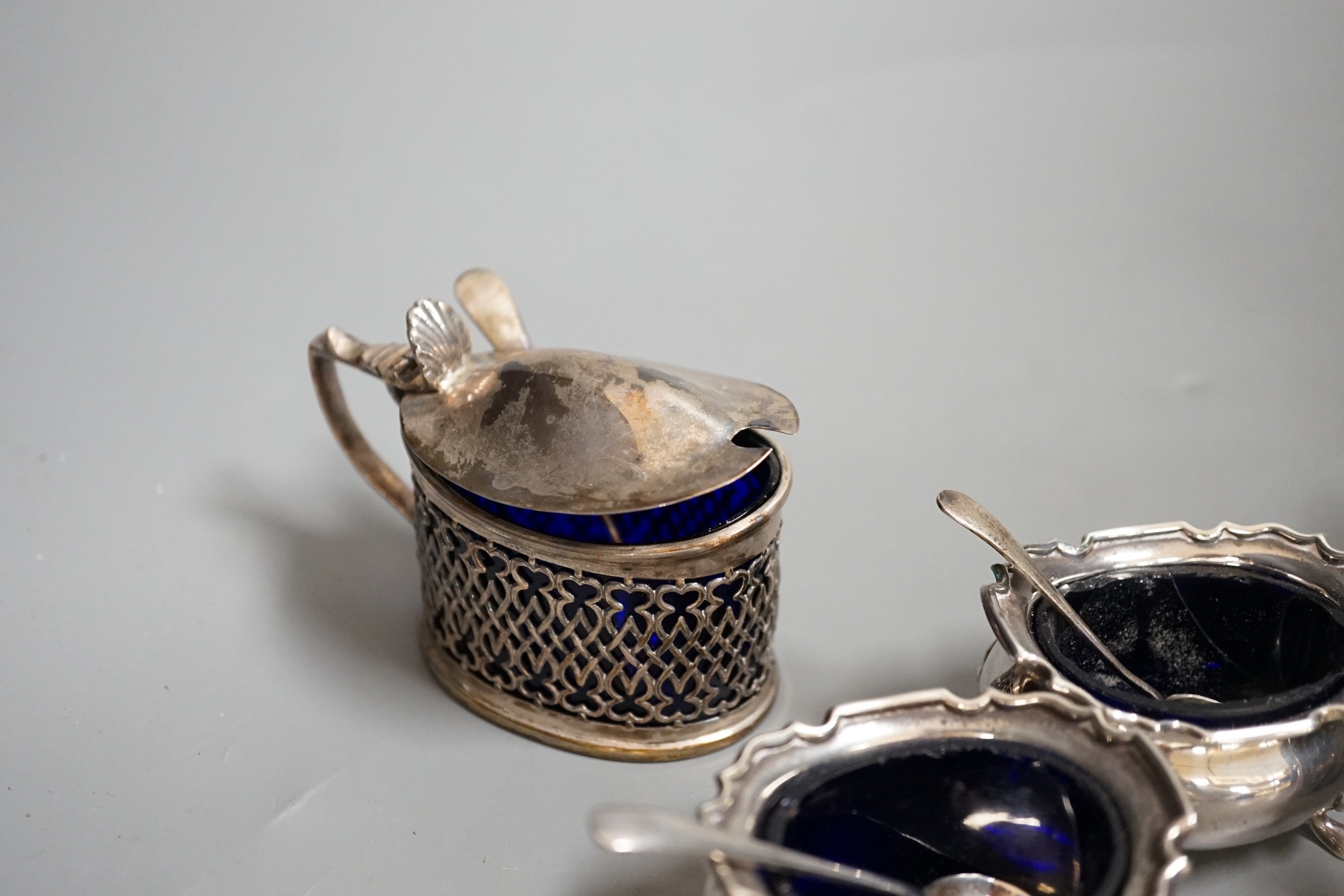 A George V silver four piece condiment set, Birmingham, 1922 and three other silver condiments.